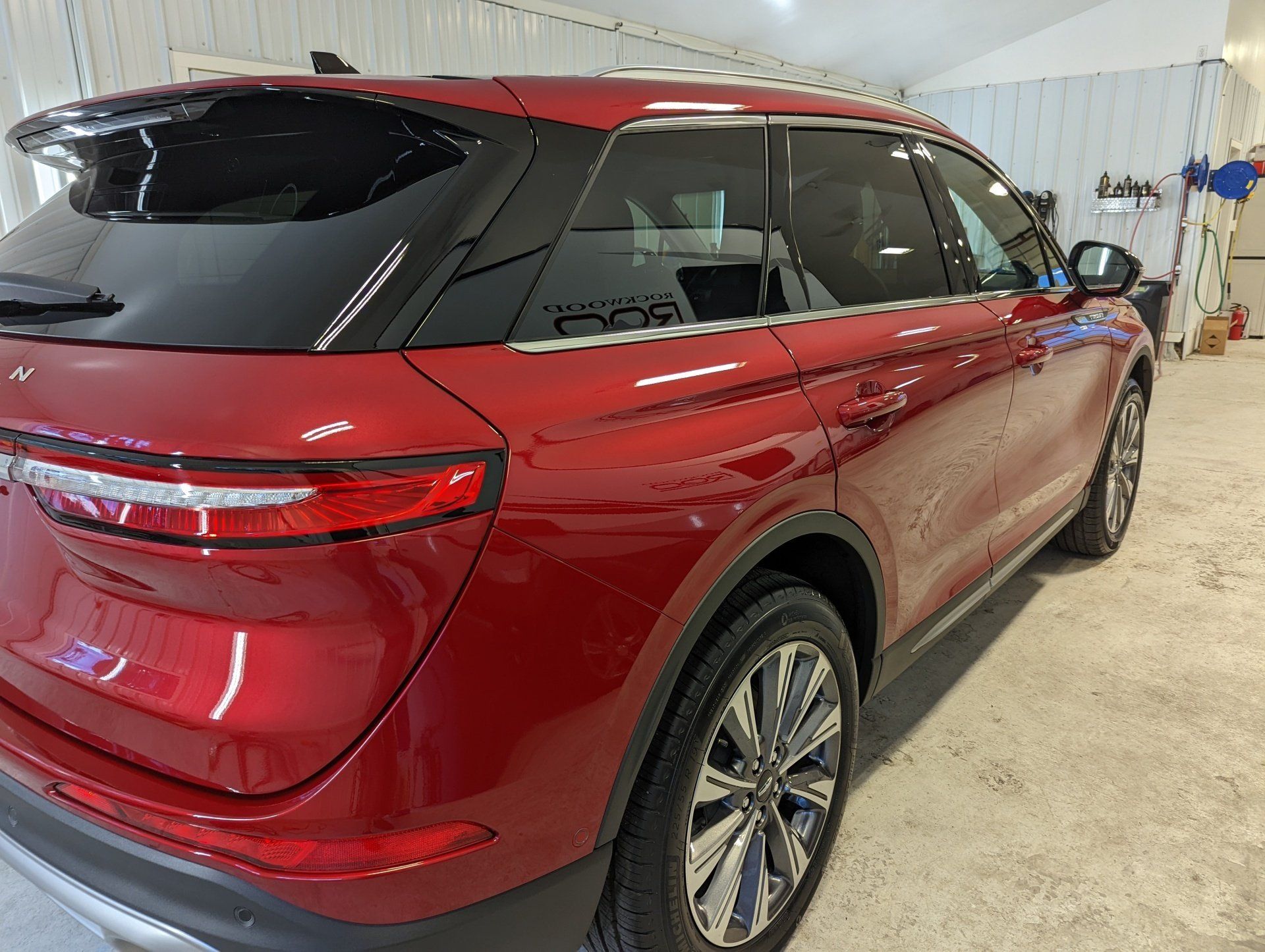 A red car is parked in a garage.