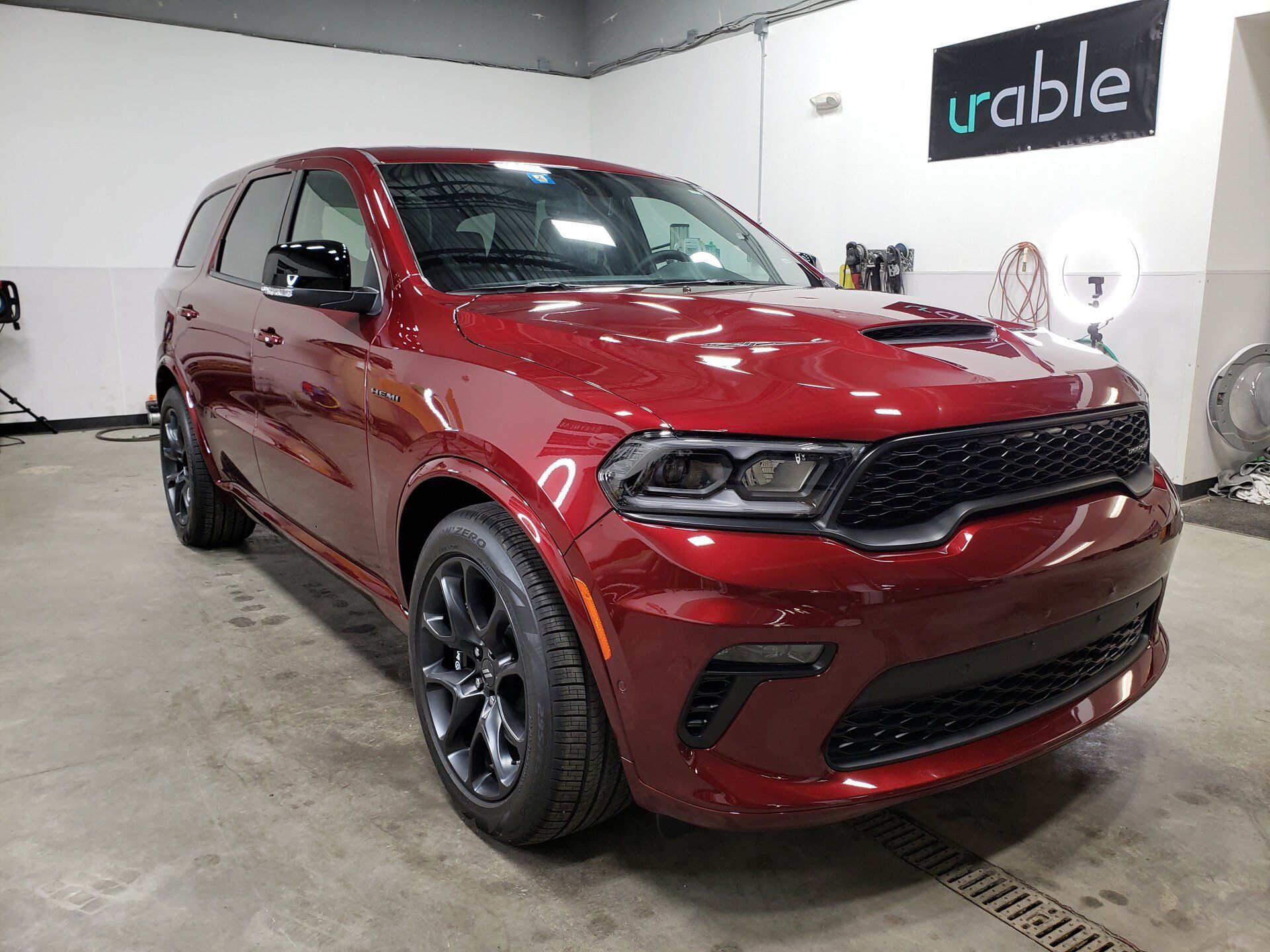 A red dodge durango is parked in a garage.