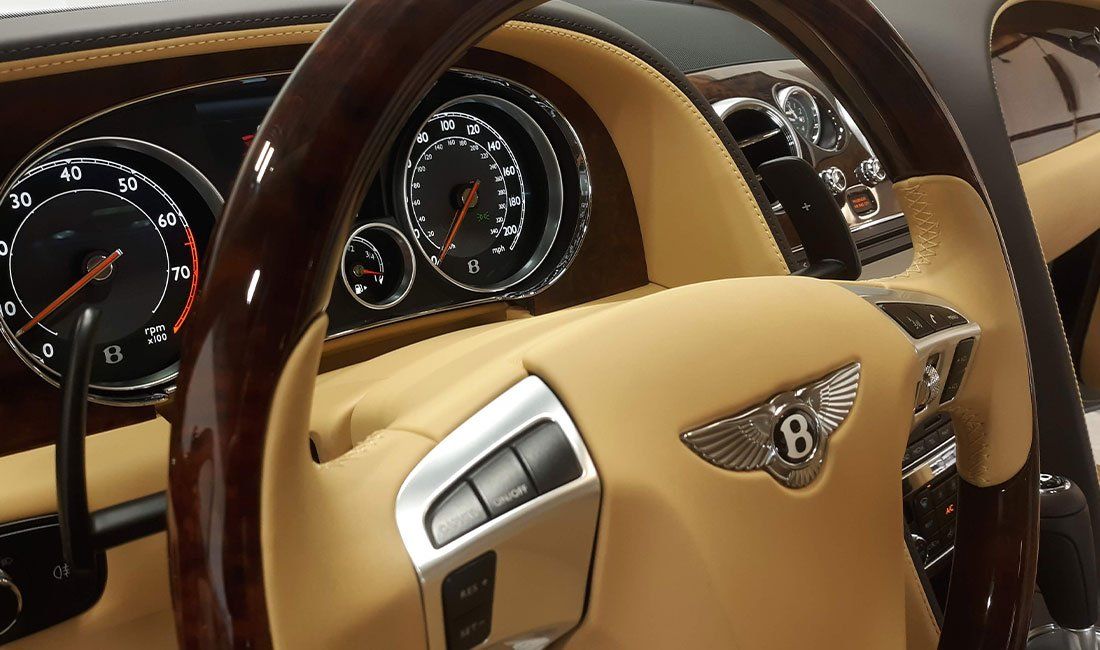 A bentley car has a wooden steering wheel