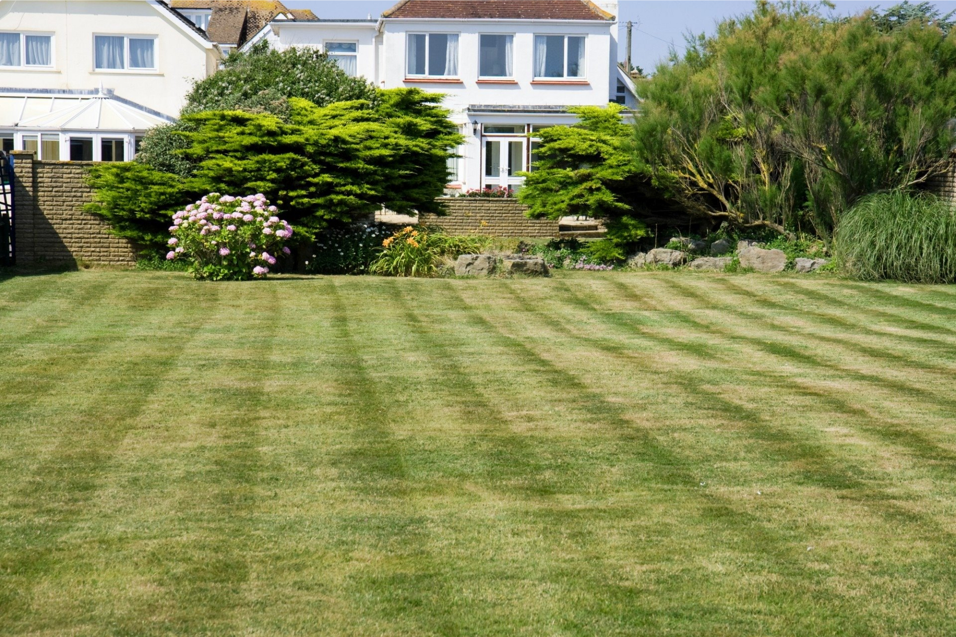 A large house with a lush green lawn in front of it