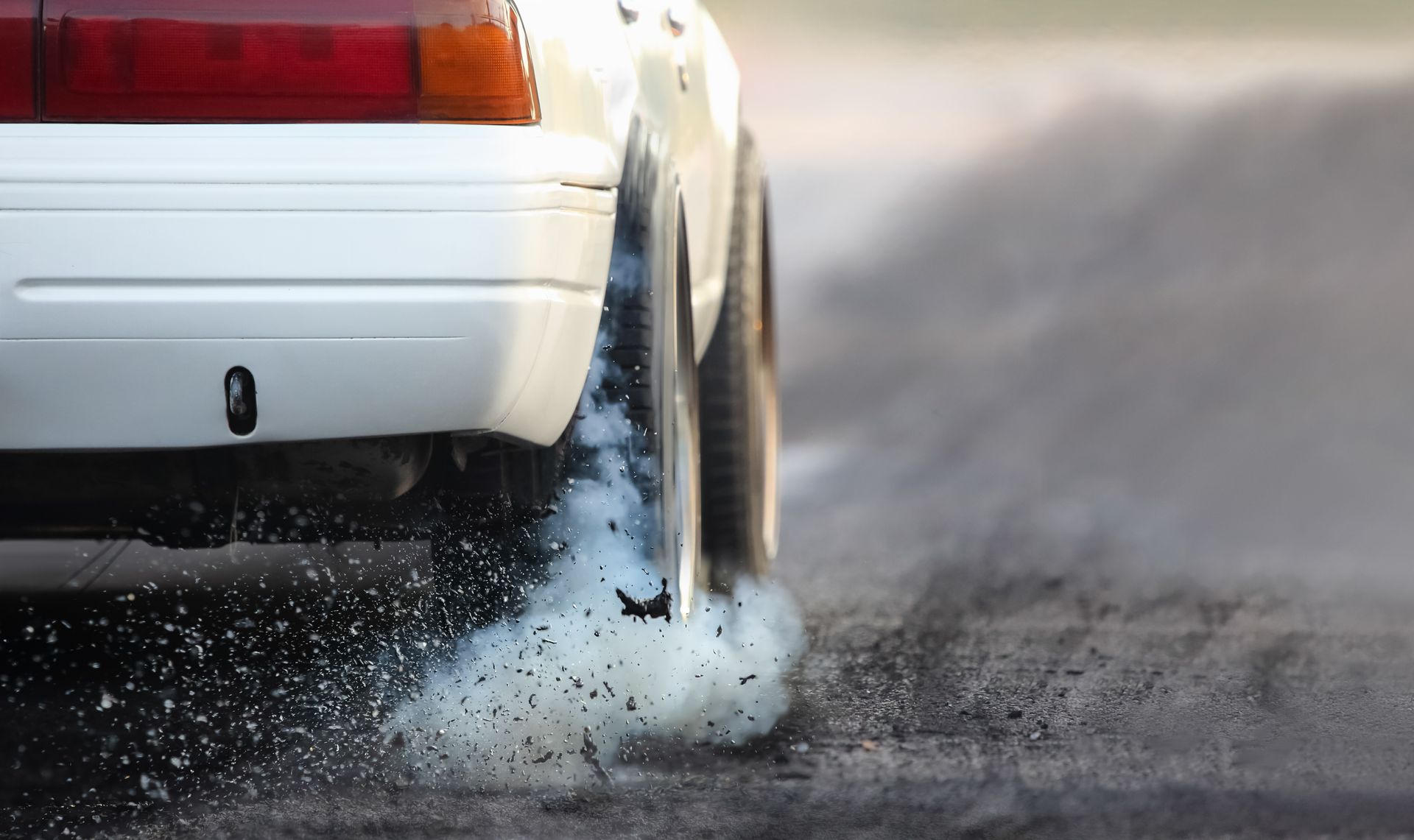 A car with smoke coming out of the exhaust pipe