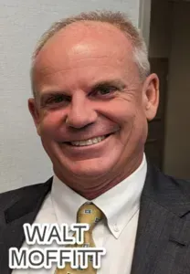 A man in a suit and tie is smiling for the camera.