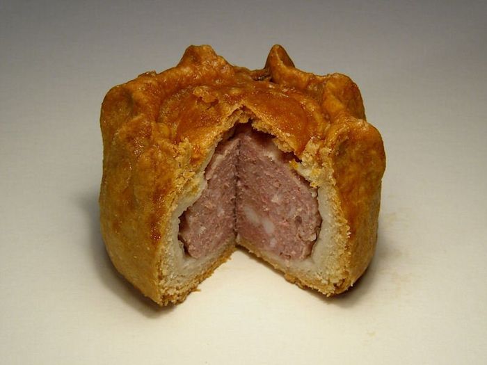 A pork pie that has been cut in half
