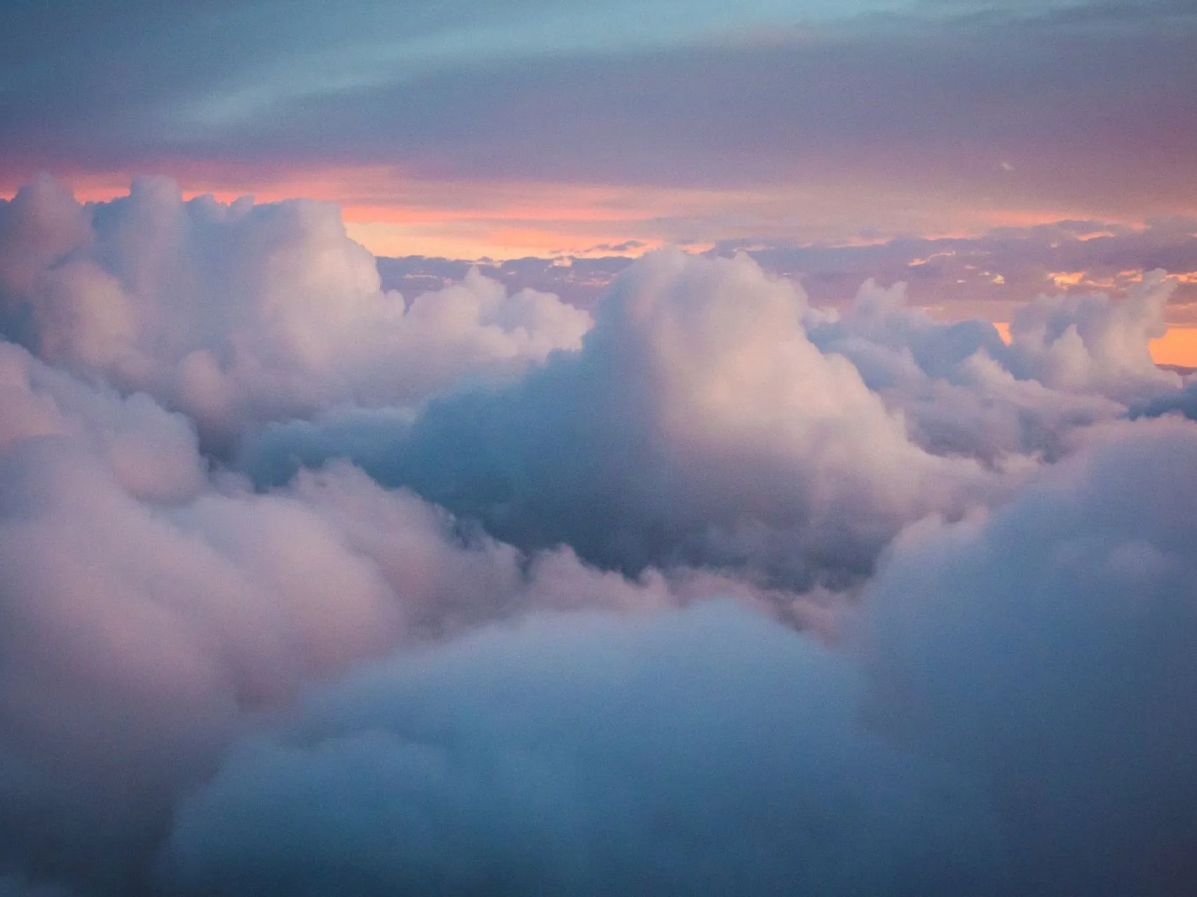 An aerial view of a cloudy sky at sunset.