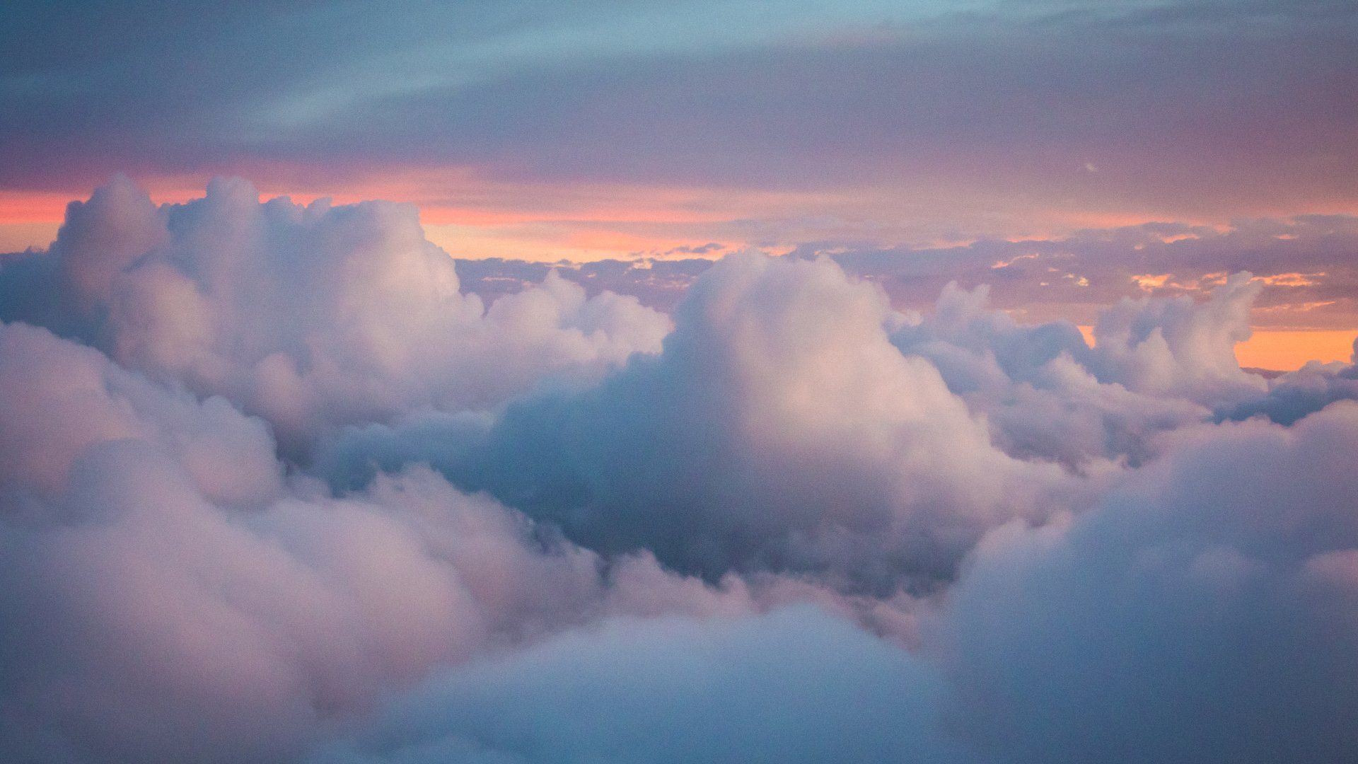 An aerial view of a cloudy sky at sunset.