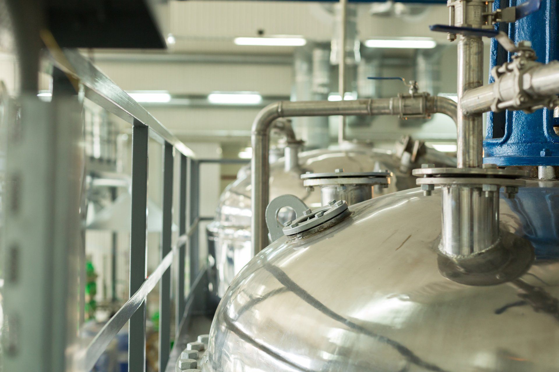 A close up of a stainless steel tank in a factory.