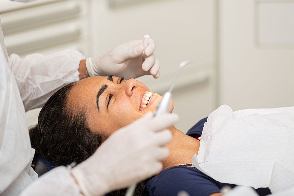 Young woman being seen in a dentist's office