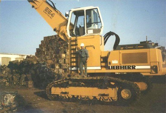 Scrap Metal Recycling — Man Standing on Work Equipment in Dayton, OH