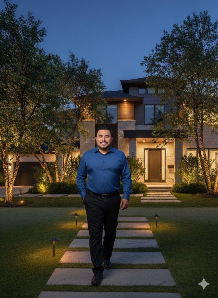 Man walking towards a modern home at dusk on a lighted pathway.