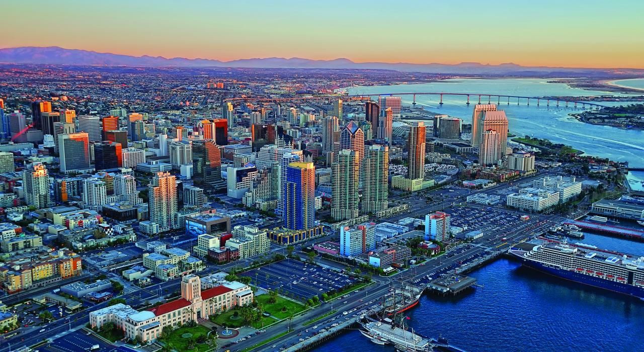 An aerial view of a city with a large body of water in the foreground.