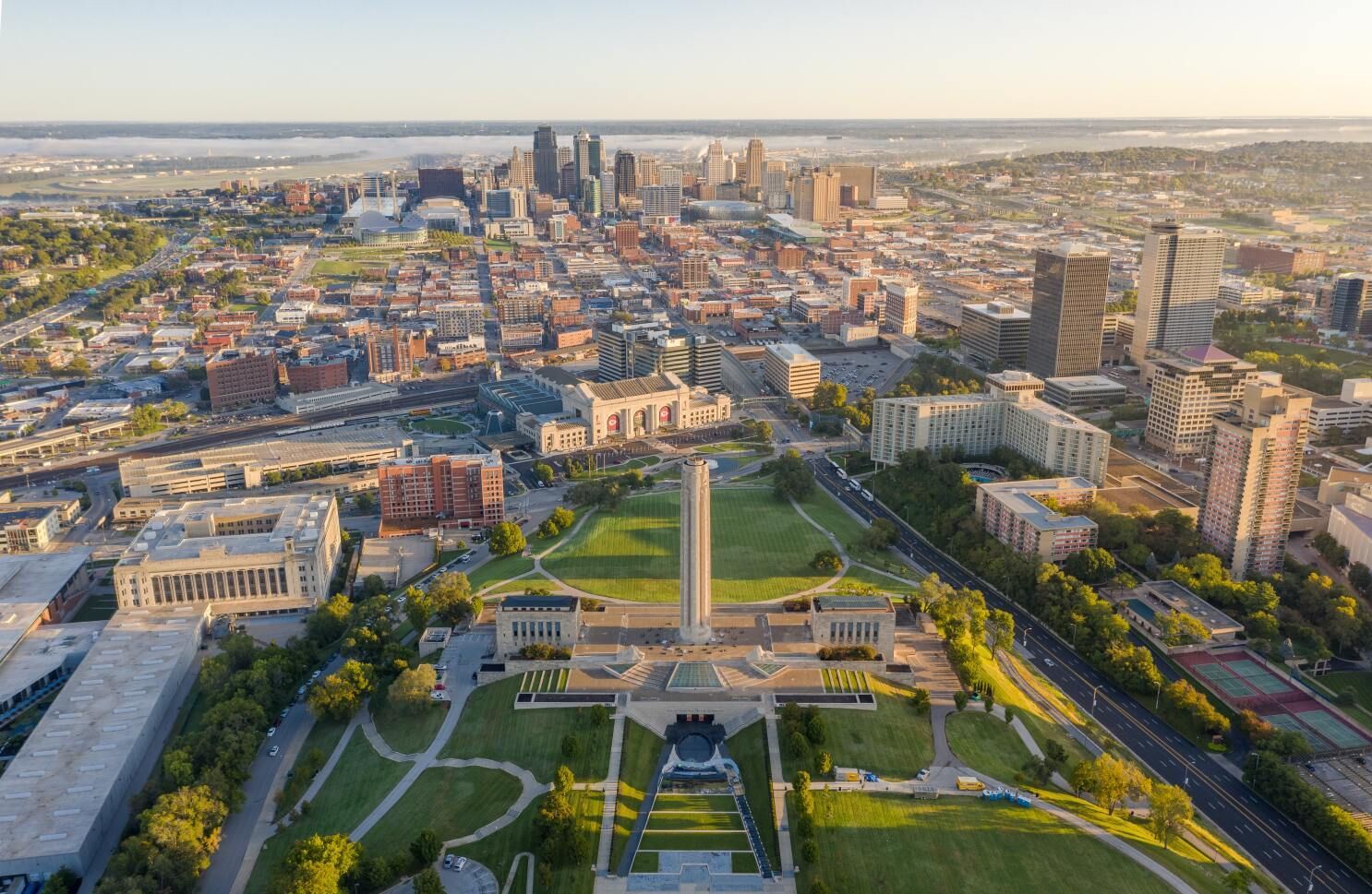 An aerial view of a city with a monument in the middle of it.