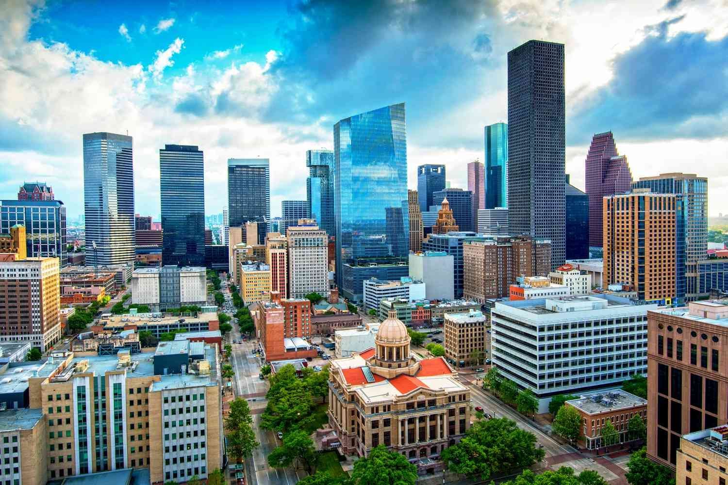 An aerial view of a city skyline with a courthouse in the foreground.