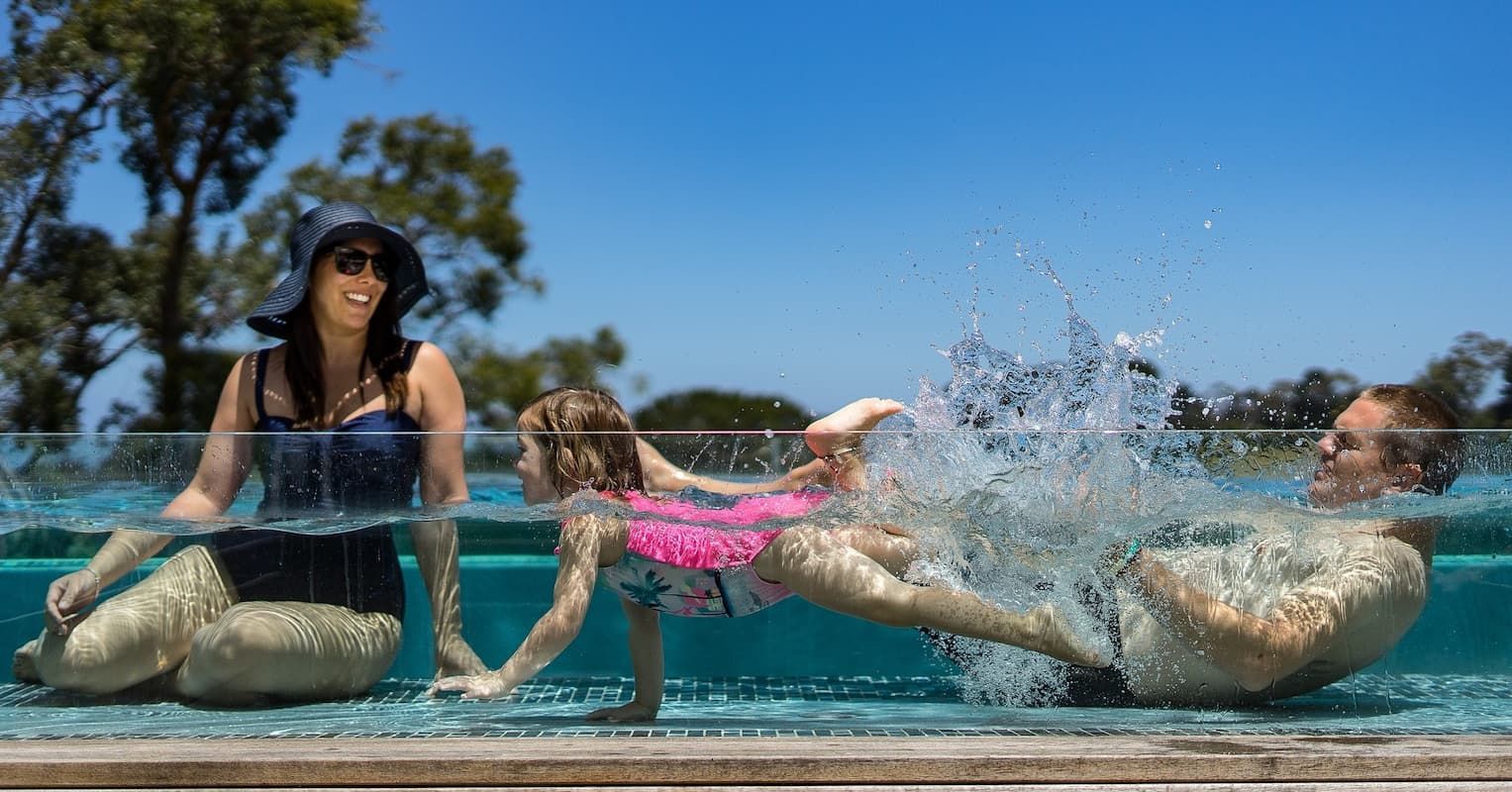 A Family is Playing in a Swimming Pool — Pooltech NT In Alawa, NT
