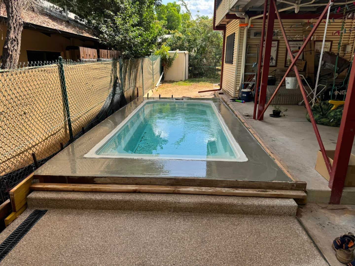 A Swimming Pool is Being Built in the Backyard of a House — Pooltech NT In Alawa, NT