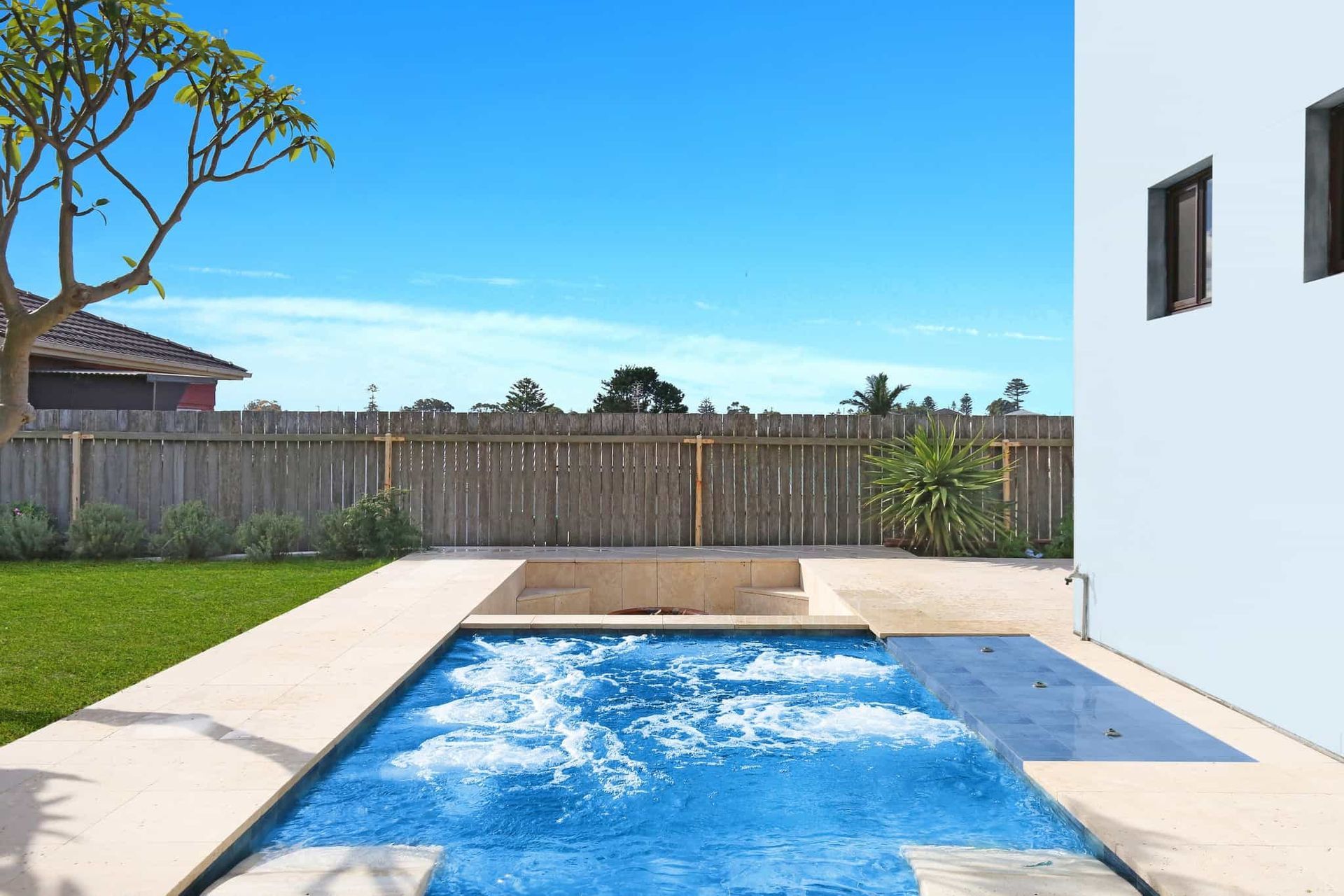 A Large Swimming Pool is in the Backyard of a House — Pooltech NT In Alawa, NT