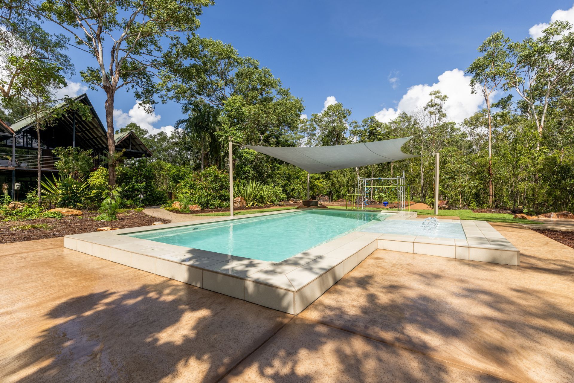 A Large Swimming Pool Surrounded by Trees and A Canopy — Pooltech NT In Alawa, NT