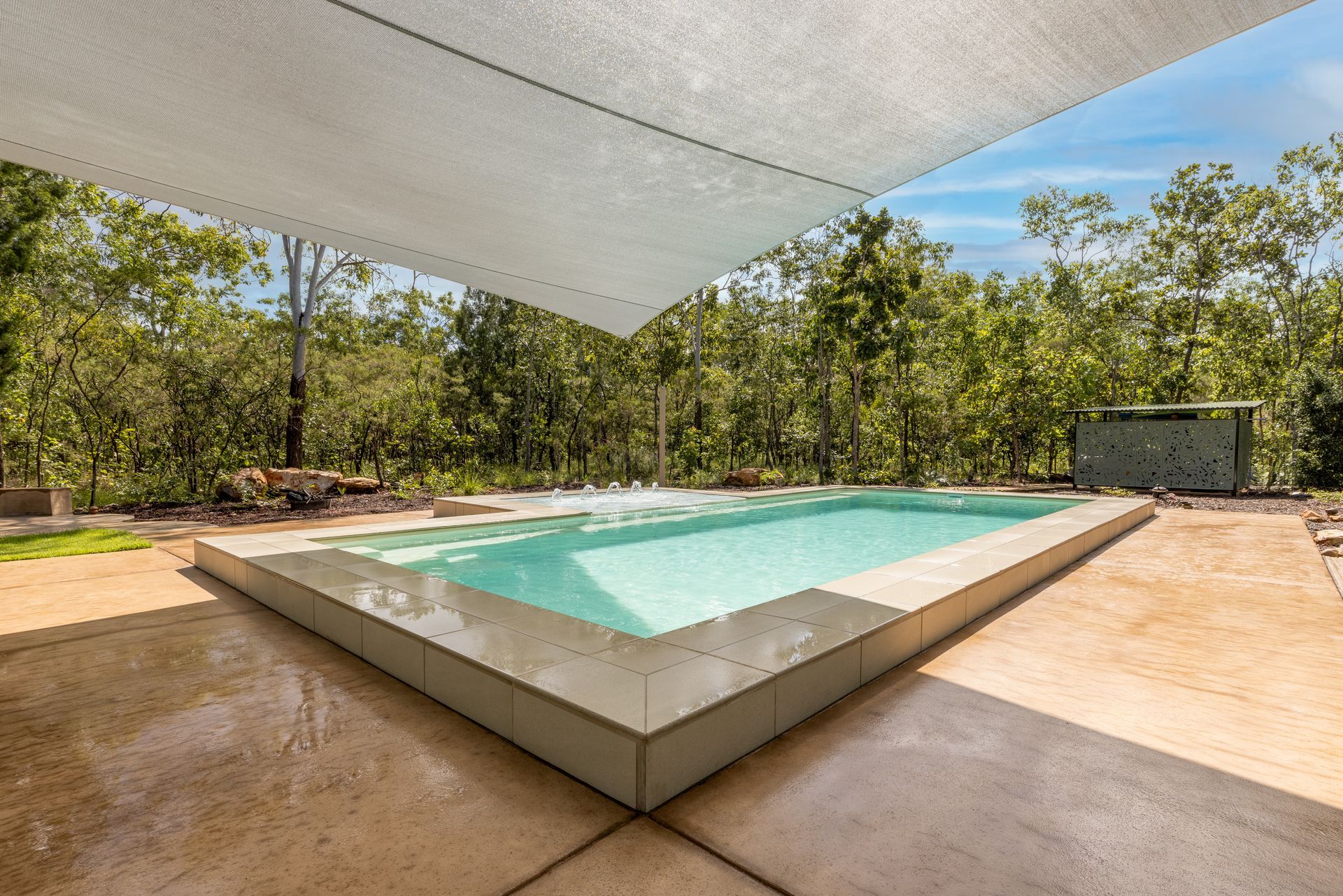 A Large Swimming Pool with A White Umbrella Over It Surrounded by Trees — Pooltech NT In Alawa, NT