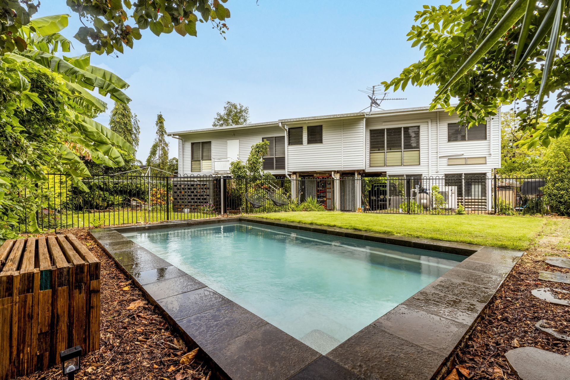 A Large House with A Swimming Pool in Front of It — Pooltech NT In Alawa, NT