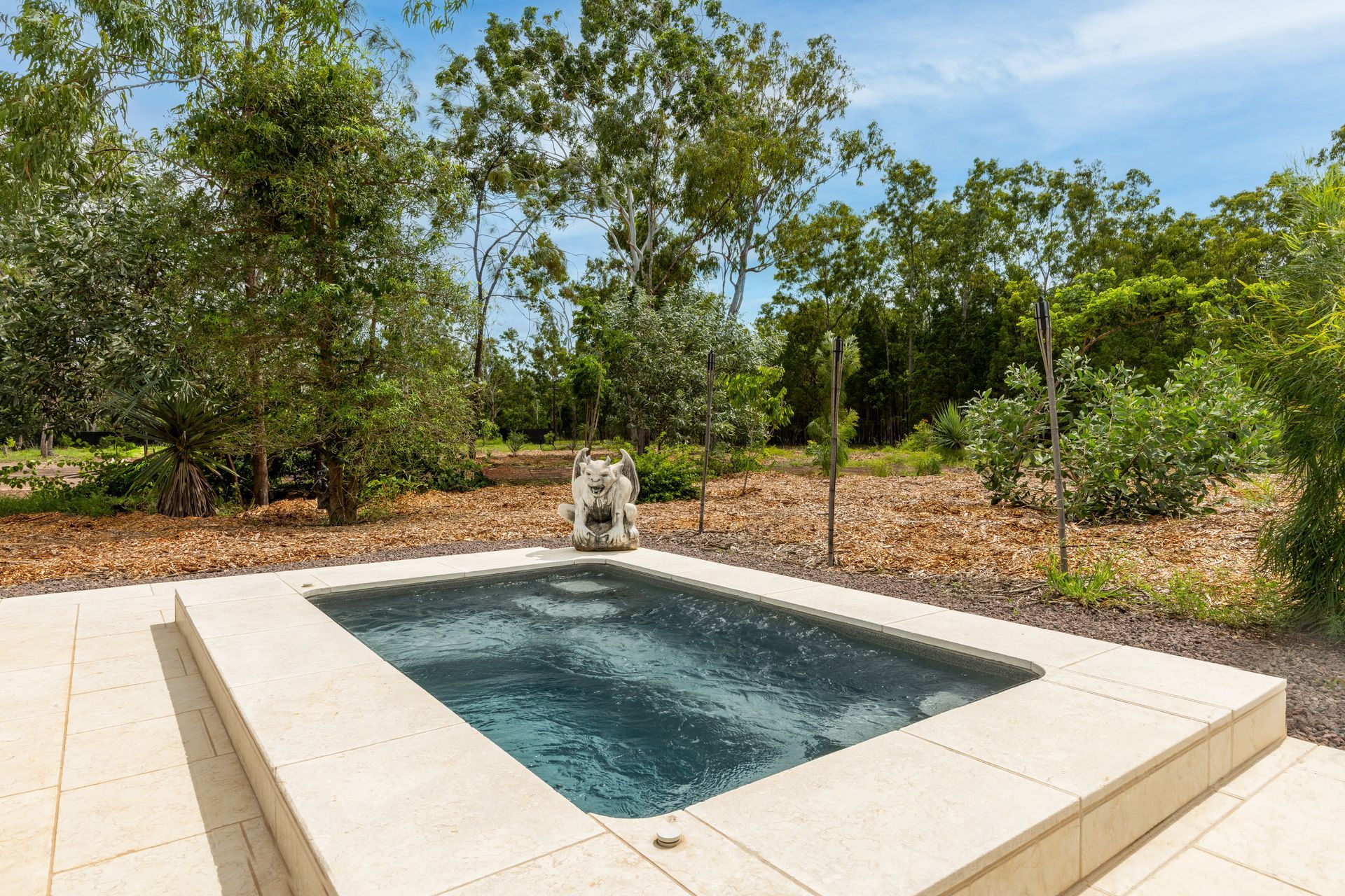 A Small Swimming Pool with A Fountain in The Middle of It Surrounded by Trees — Pooltech NT In Alawa, NT