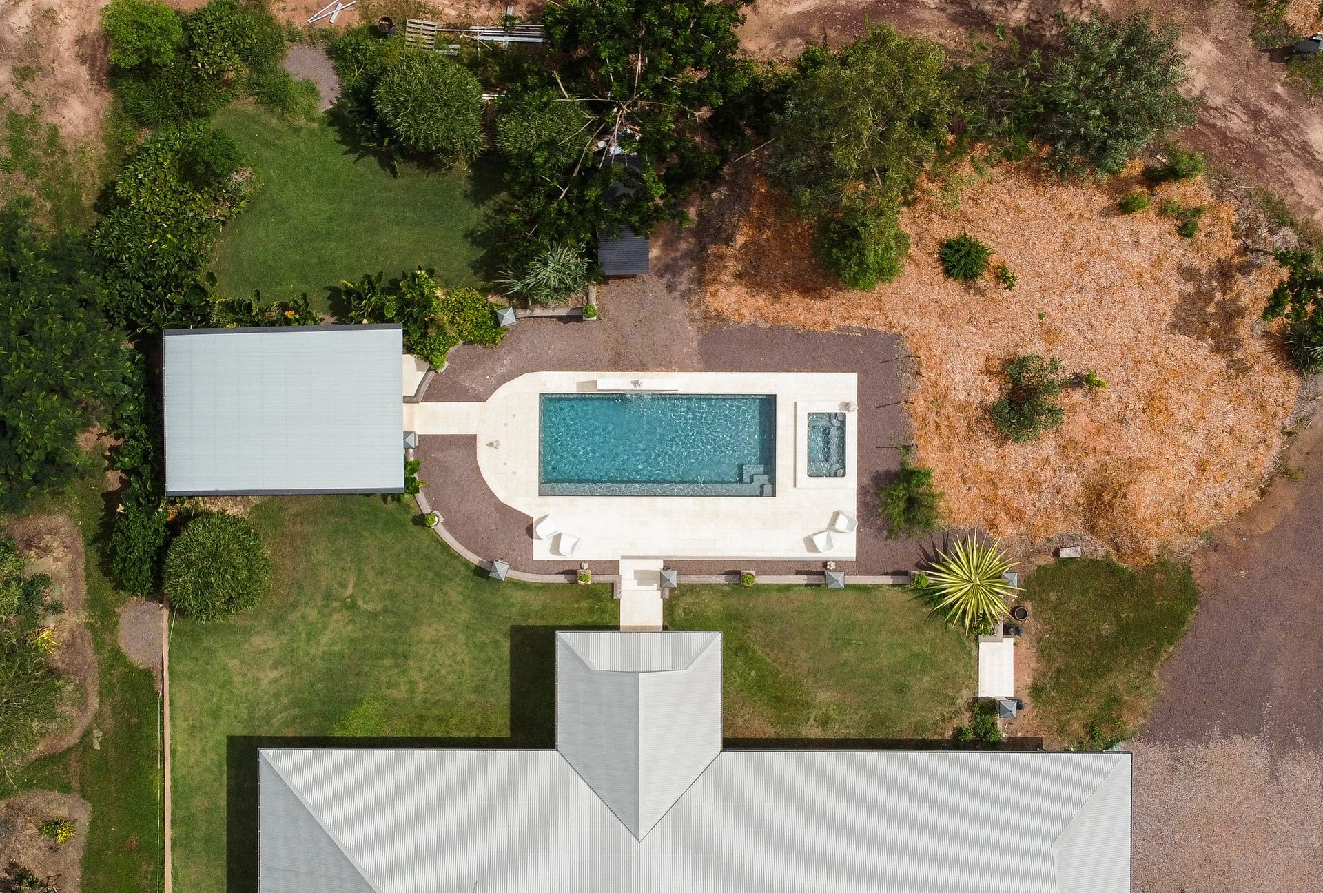 An Aerial View of A House with A Large Swimming Pool in The Backyard — Pooltech NT In Alawa, NT