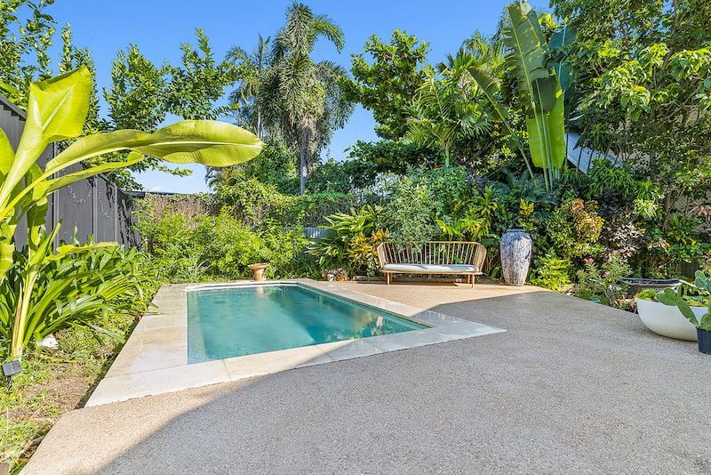 A Large Swimming Pool in the Middle of a Lush Green Garden — Pooltech NT In Alawa, NT