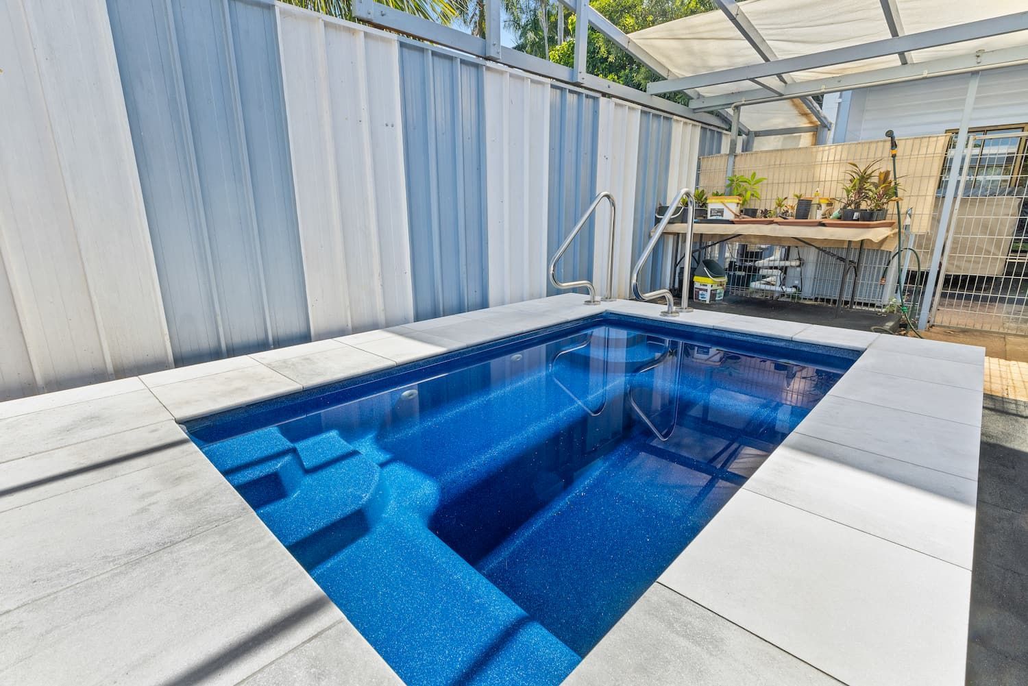 A Small Swimming Pool is Sitting Under a Canopy in a Backyard — Pooltech NT In Alawa, NT