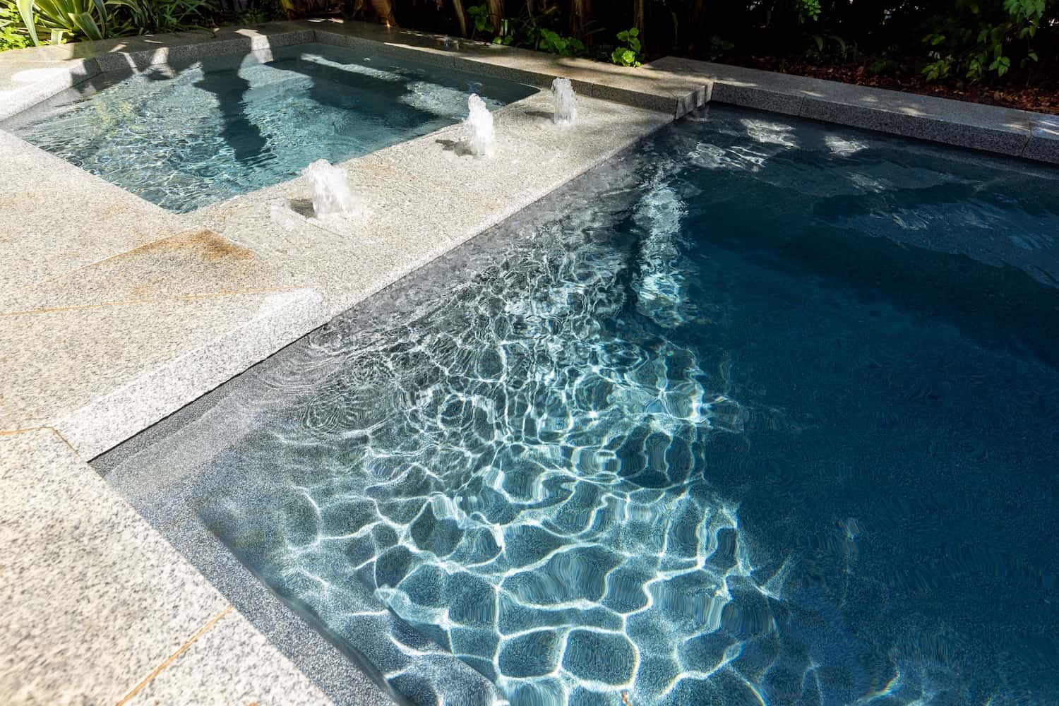 A Swimming Pool With a Hot Tub Next to It — Pooltech NT In Alawa, NT