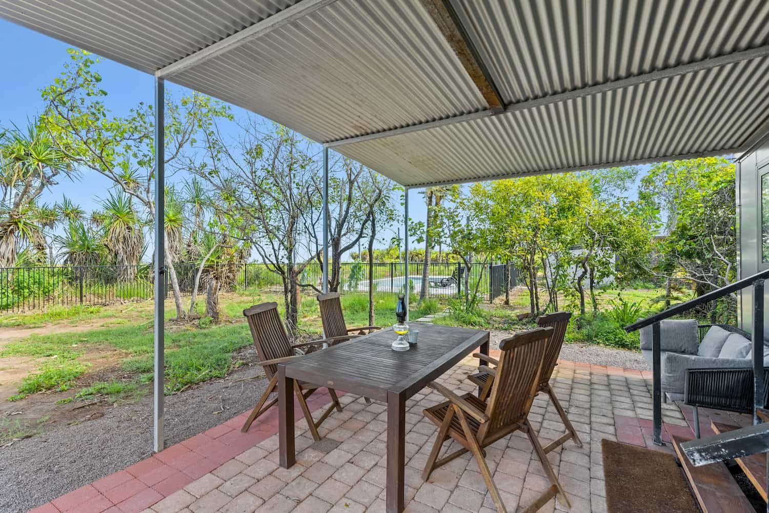 A Fence Surrounds a Swimming Pool in a Yard — Pooltech NT In Alawa, NT