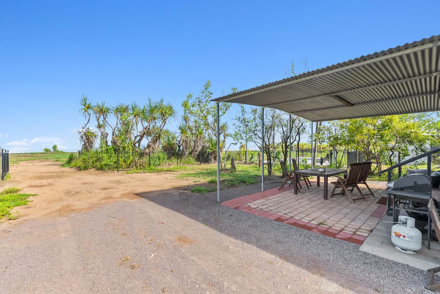 A Patio With a Table and Chairs Under a Canopy — Pooltech NT In Alawa, NT