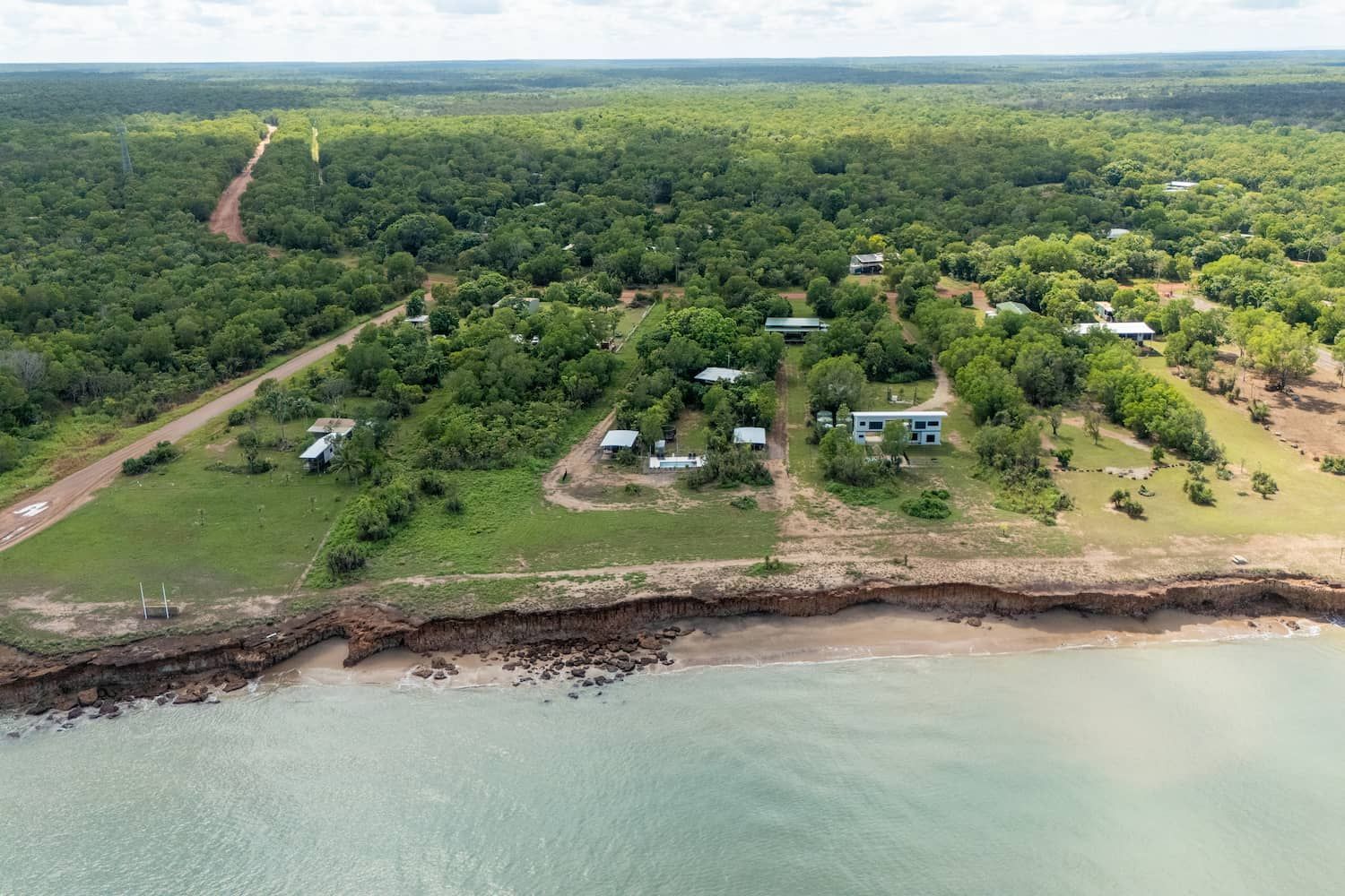 An Aerial View of a Lush Green Forest Next to a Body of Water — Pooltech NT In Alawa, NT