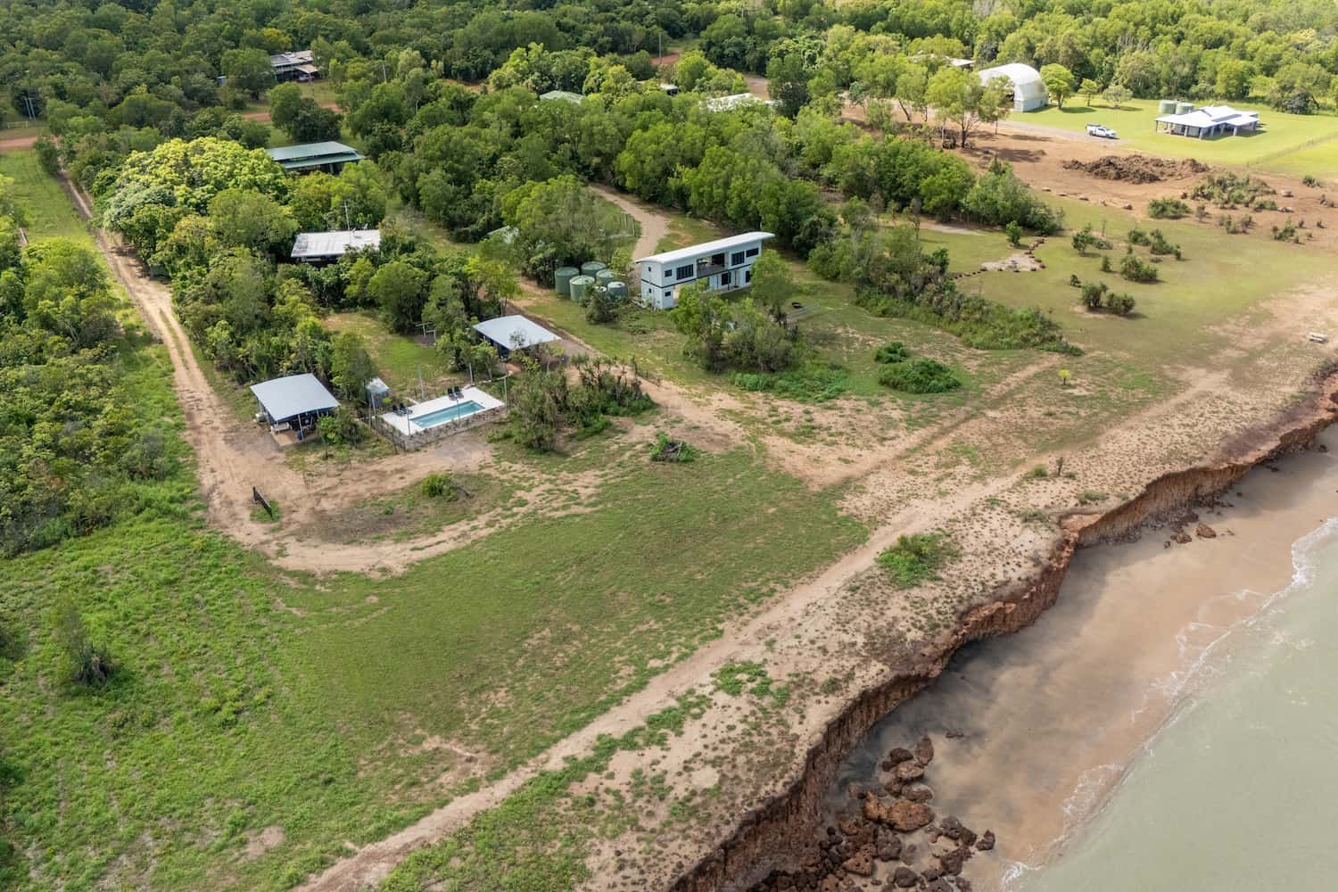 An Aerial View of a House on a Cliff Overlooking the Ocean — Pooltech NT In Alawa, NT