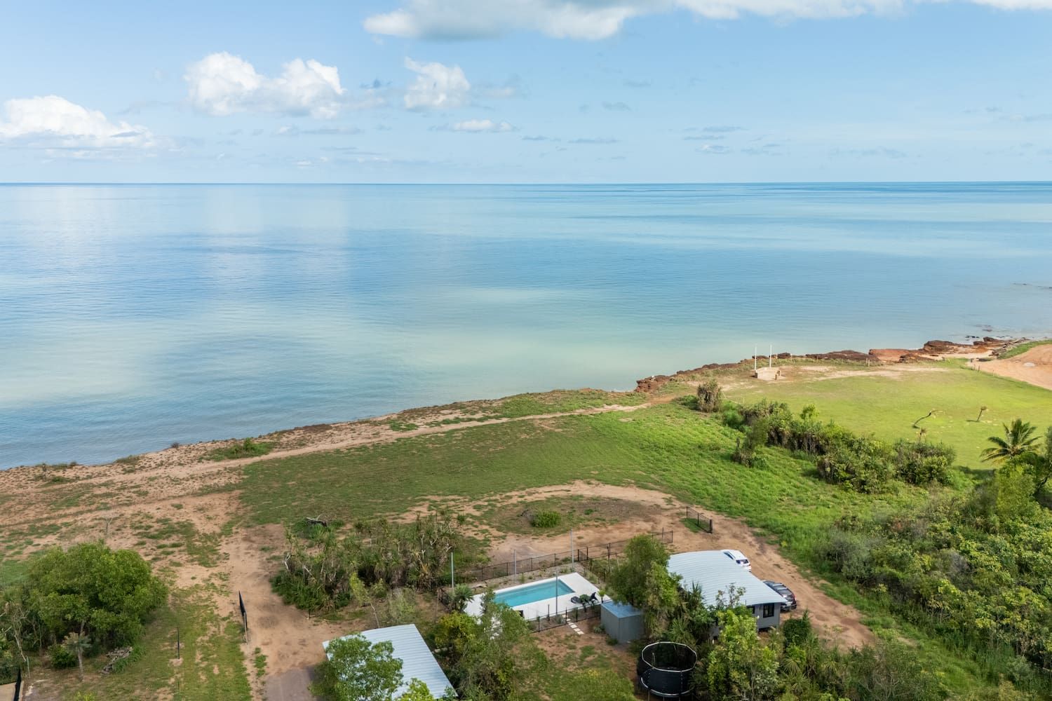 An Aerial View of a House Overlooking the Ocean — Pooltech NT In Alawa, NT