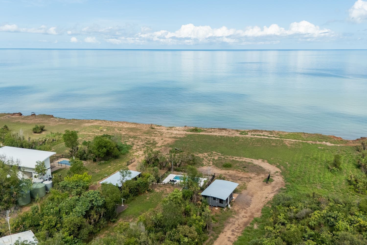 An Aerial View of a House on a Cliff Overlooking the Ocean — Pooltech NT In Alawa, NT