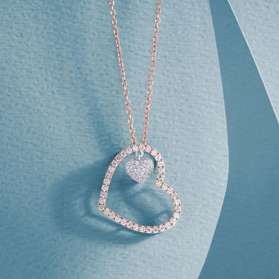 A necklace with a heart shaped pendant on a chain