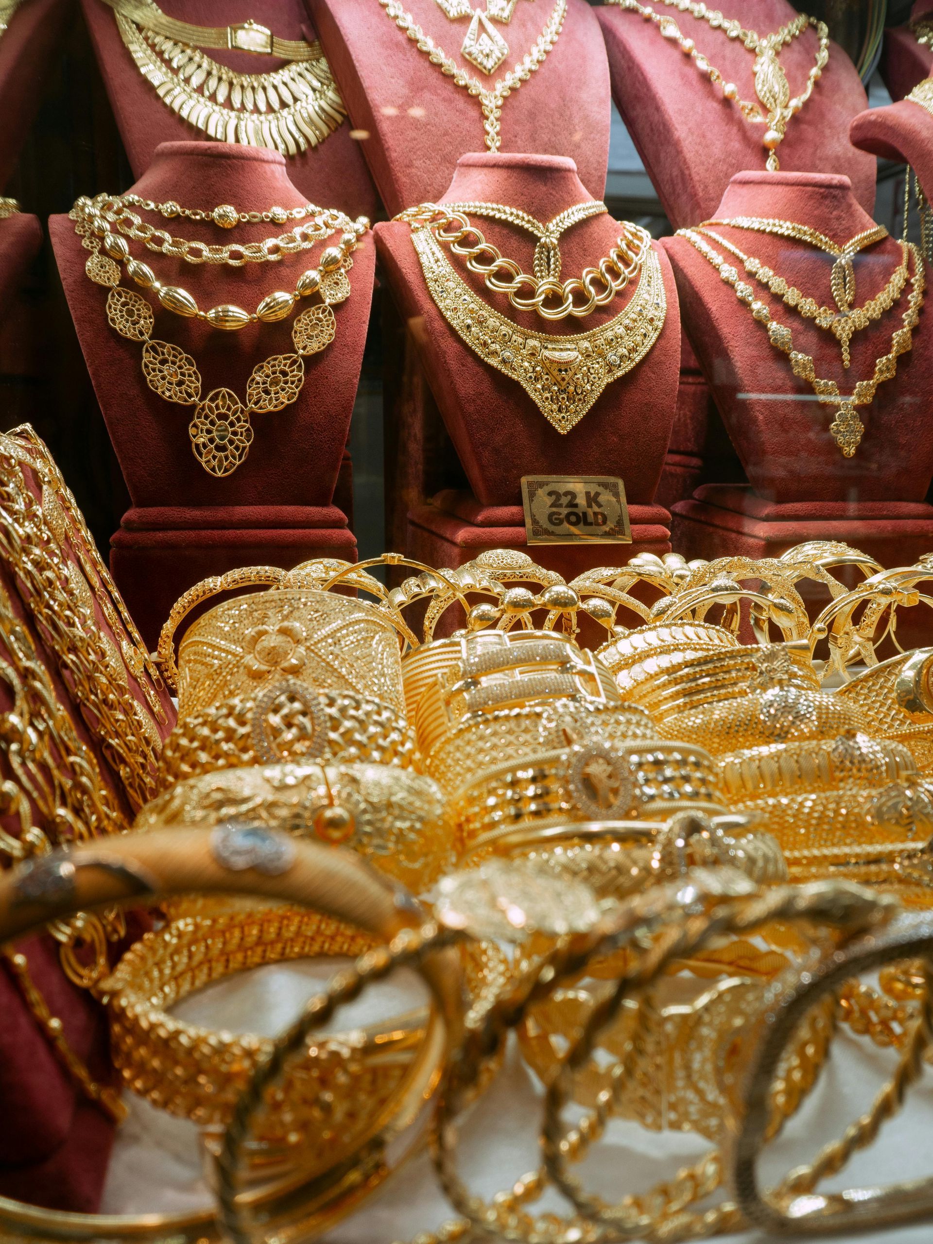 A display of gold jewelry including necklaces and bracelets
