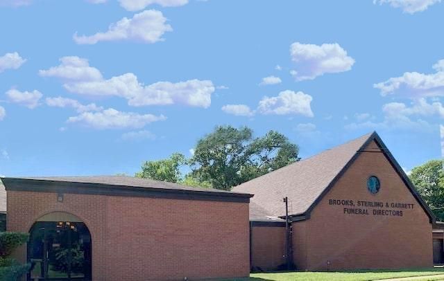 A large office building with a lot of windows on a sunny day.