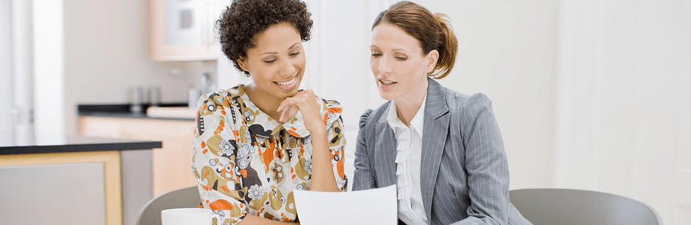 two women looking at paperwork