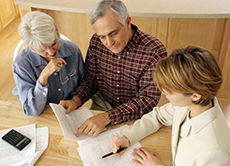 man and two women looking at paperwork