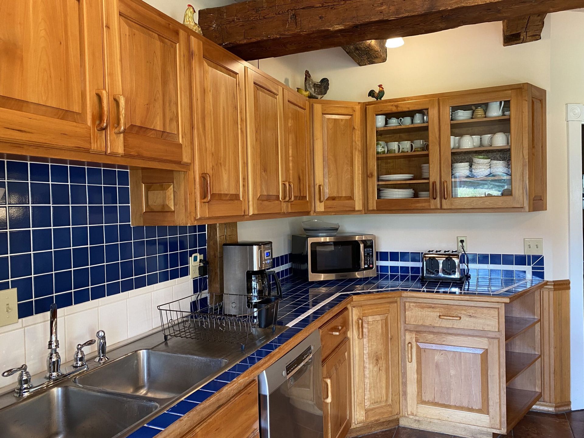 A kitchen with wooden cabinets and stainless steel appliances