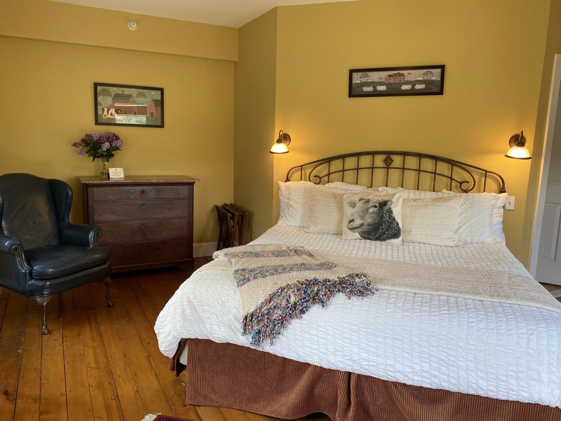 A bedroom with a king size bed and a chair