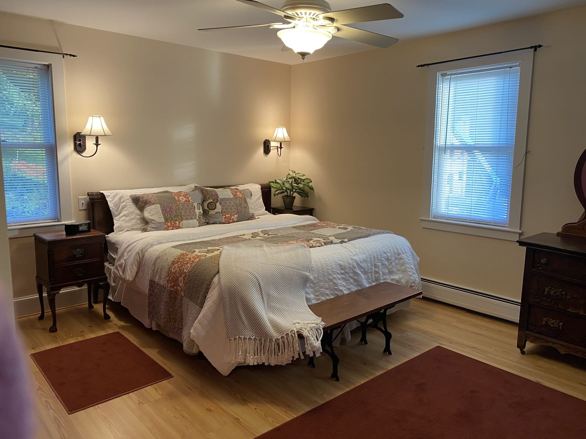 A bedroom with a king size bed and a ceiling fan.