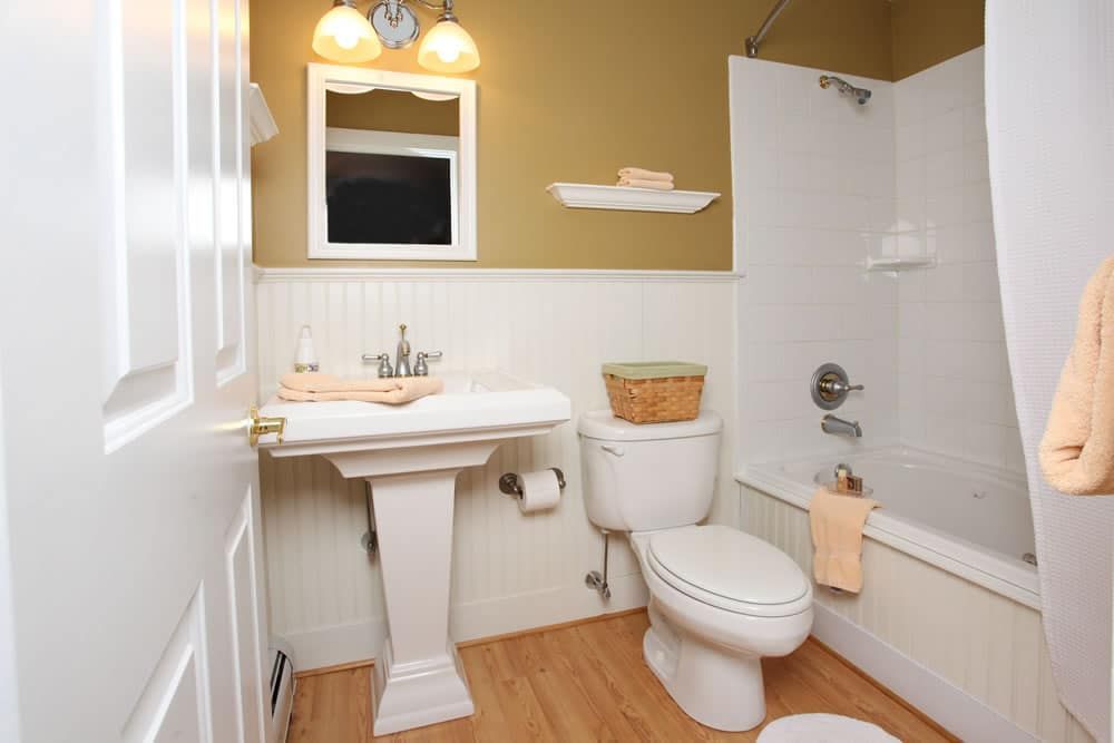 A bathroom with a toilet , sink and bathtub