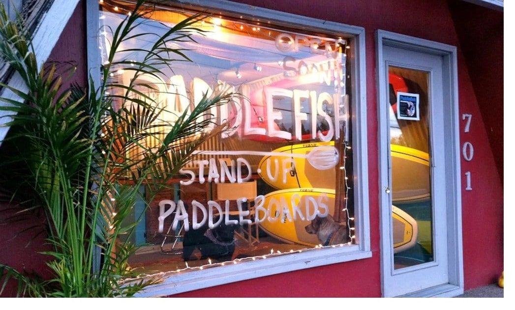 A red building with a window that says paddlefish on it