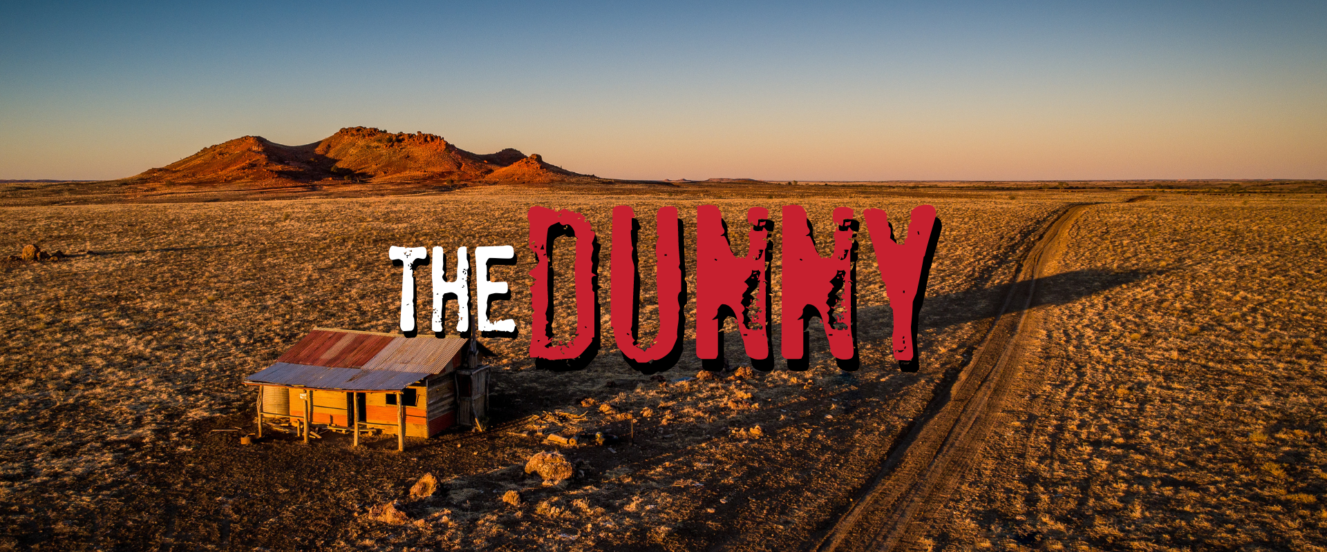 The Dunny Escape Room. A shack in the middle of the Australian outback at sunset.