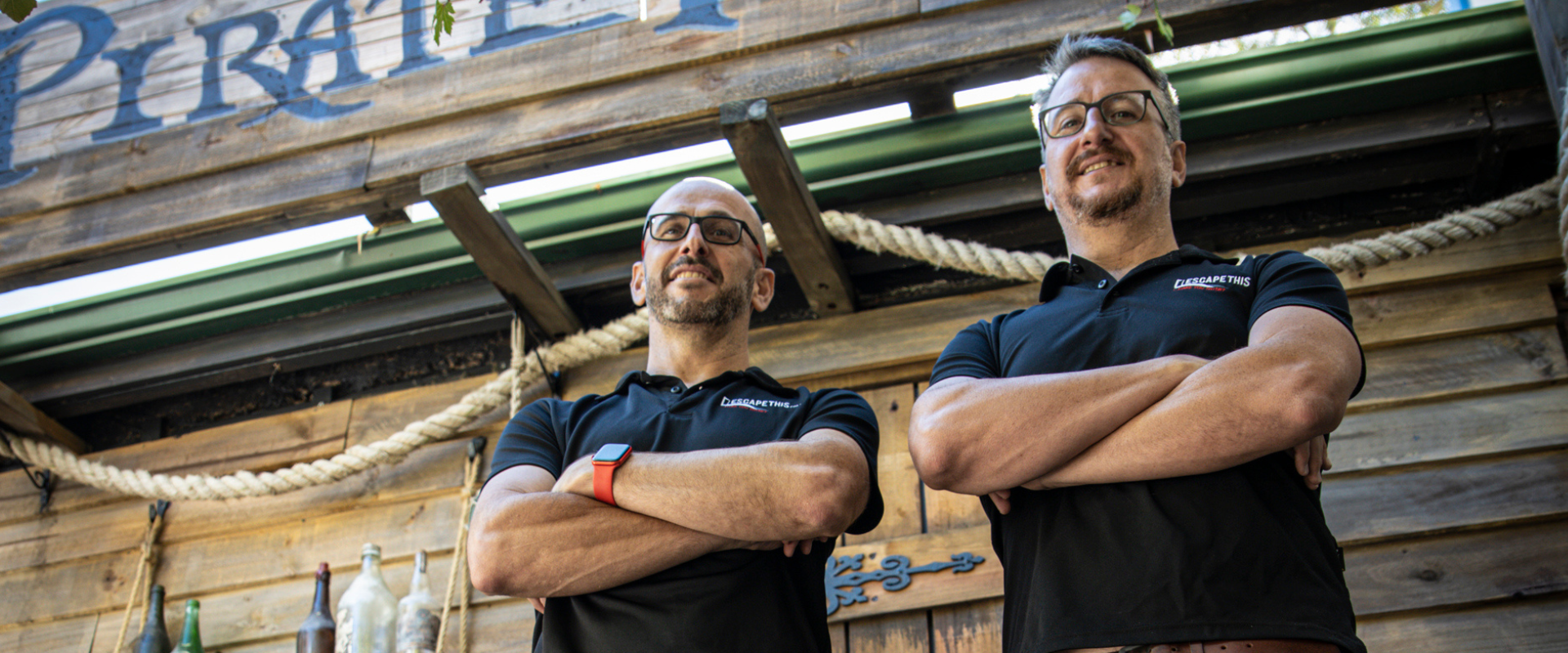 The Directors of Escape This standing and smiling in front of our Pirate Island Escape Room.