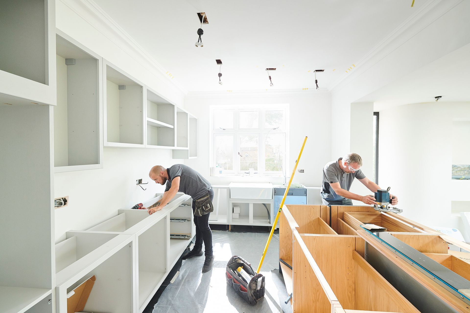 Two joiners remodeling a kitchen