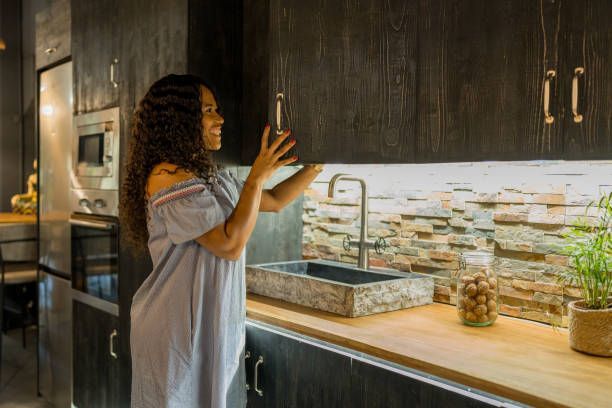A young woman is searching for food in the kitchen cupboard.