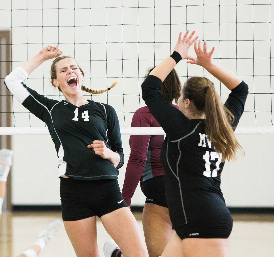 A volleyball player with the number 14 on her jersey