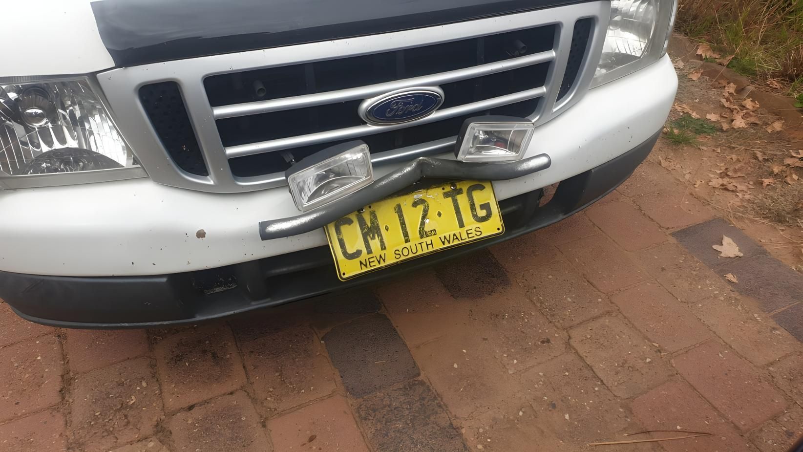 A White Ford Truck With a Yellow License Plate — M & D Shipp Smash Repairs In Dubbo, NSW