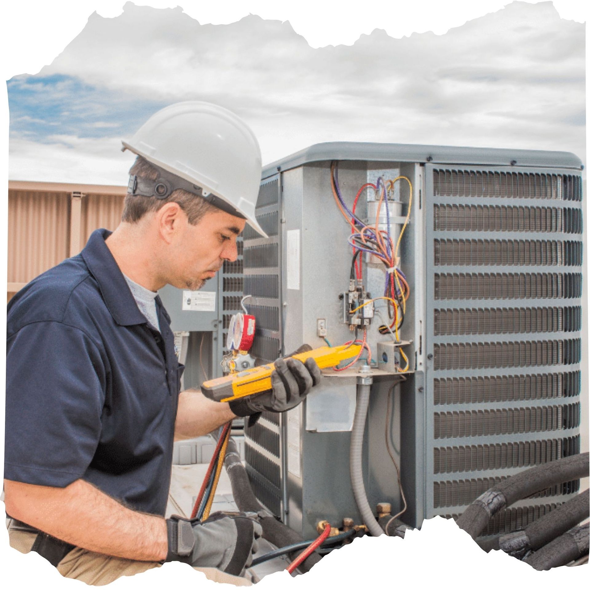 TSC-HVAC - A man wearing a hard hat is working on an air conditioner.